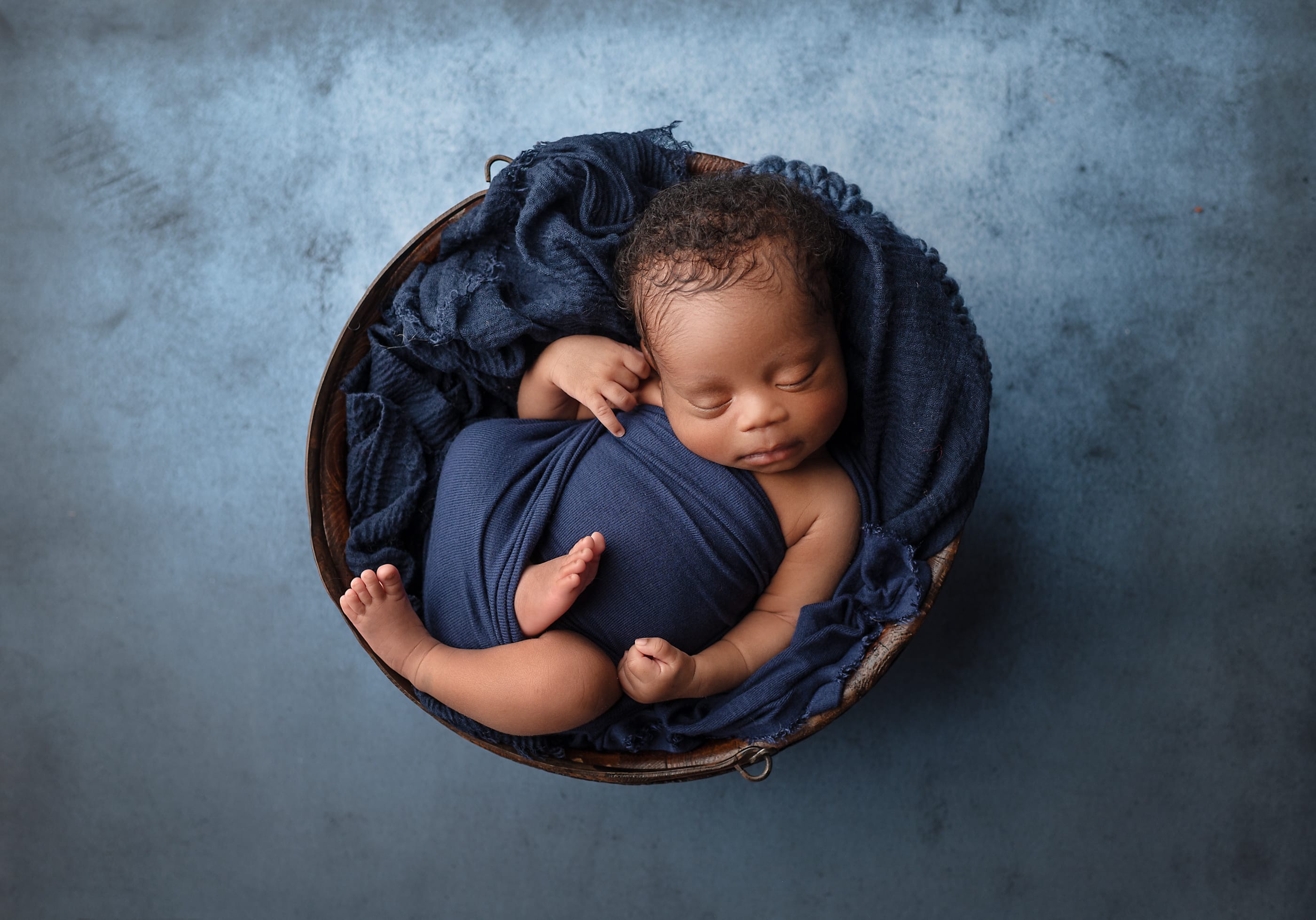2nd place competition winner of Sleeping baby posed in bowl with beautiful blue wrap and resting layer.