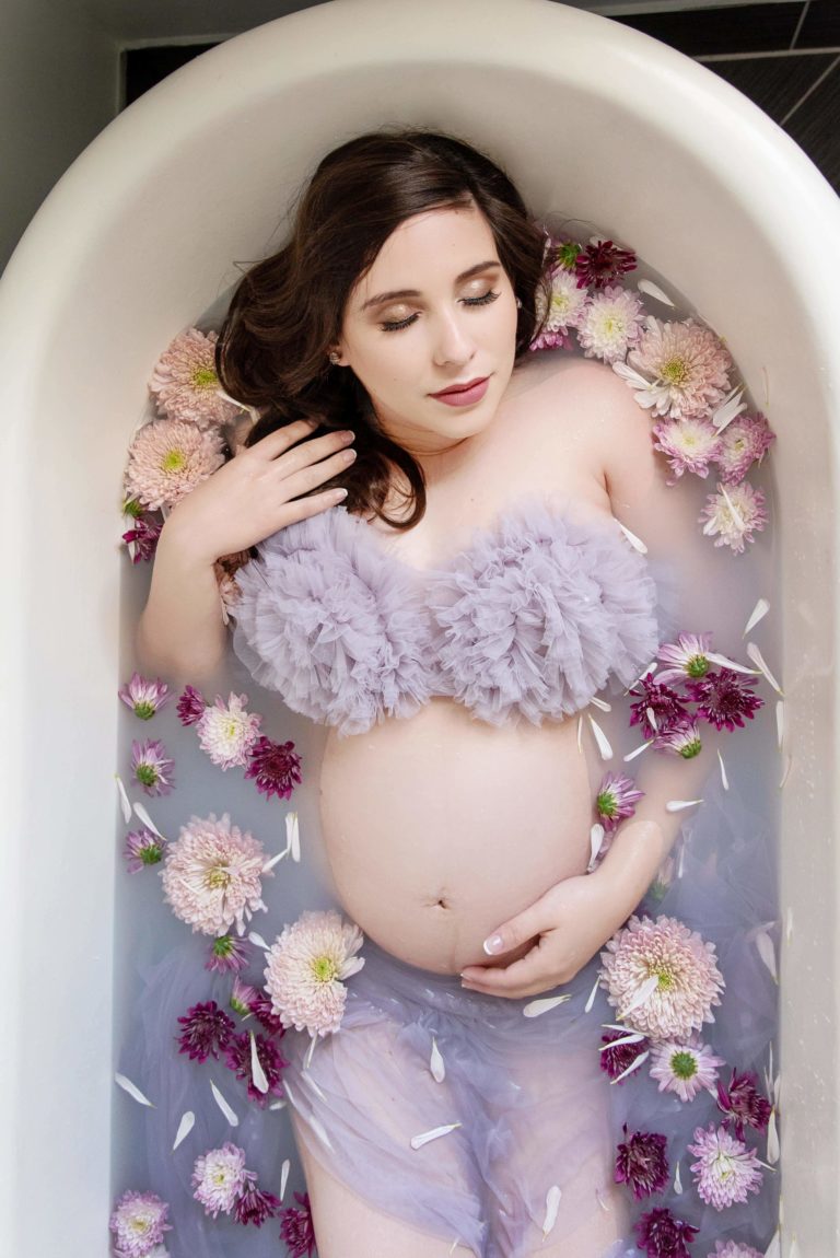 st-louis-maternity-photographer-pregnant-mom-wearing-purple-ruffle-top-in-milk-bath-with-purple-